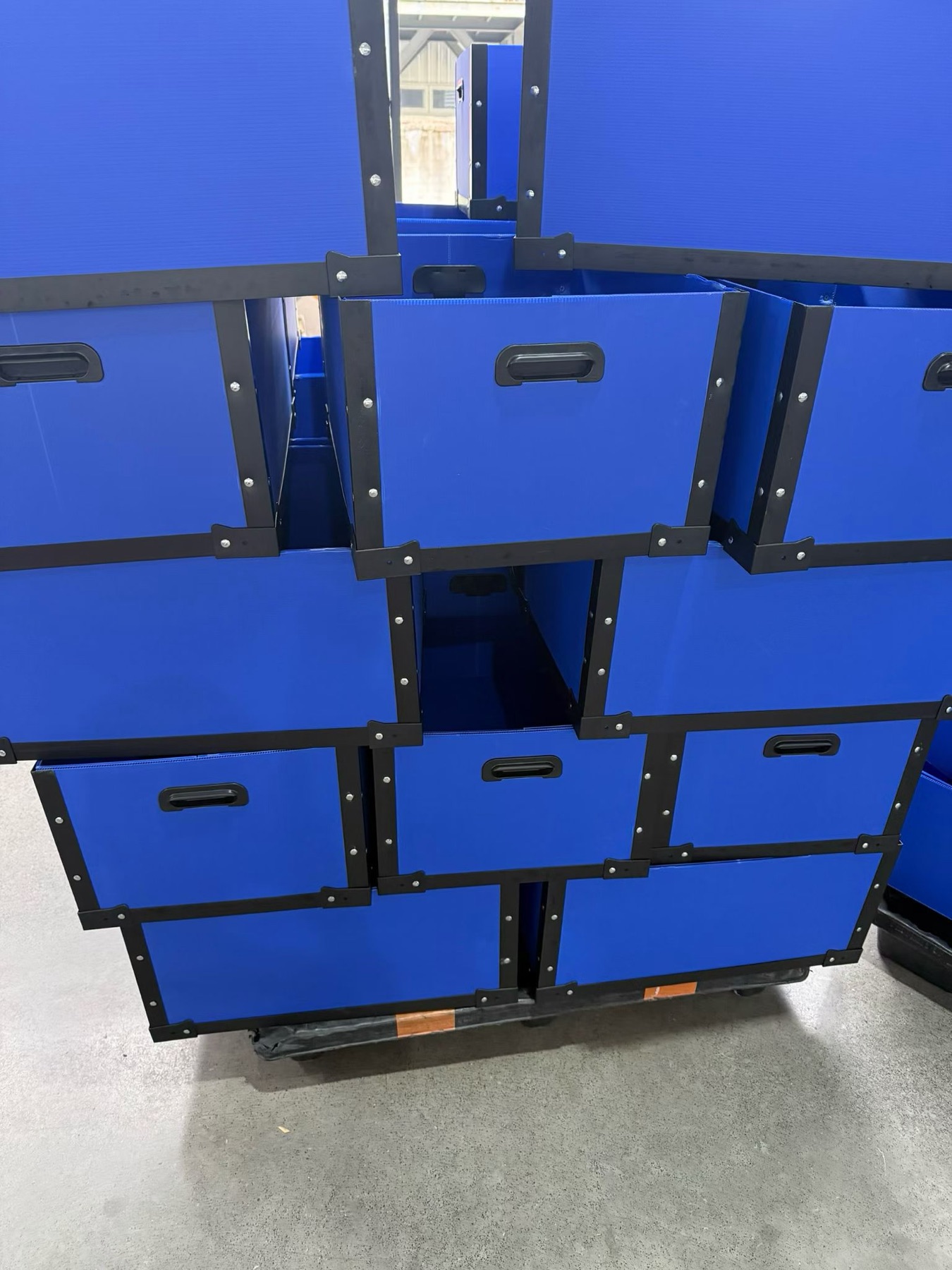 Finished blue reinforced PP corrugated boxes stacked in production
